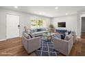 Bright living room features modern furniture, a stylish rug, and plenty of natural light at 7571 Ridge Rd, Seminole, FL 33772
