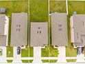 Aerial view of rooftops in a residential area with green lawns and driveways between neighboring homes at 81 Rain Lily Ave, Spring Hill, FL 34609