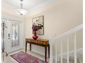 Bright foyer featuring decorative tile flooring, staircase, and beautiful glass-paneled front door at 829 Date Palm Ln, St Petersburg, FL 33707