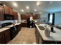 Spacious kitchen with stainless steel appliances, granite countertops, and a center island at 10108 Rosemary Leaf Ln, Riverview, FL 33578