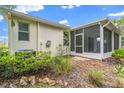 Private backyard featuring a screened-in porch and lush landscaping, ideal for outdoor relaxation at 11144 Paradise Point Way, New Port Richey, FL 34654