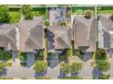 Aerial view of the property showing the roof, solar panels, driveway, backyard patio and surrounding neighborhood at 11539 Tangle Branch Ln, Gibsonton, FL 33534
