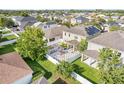 Aerial view of a backyard showcasing a geometric patio, lush green lawn, and a white privacy fence at 11539 Tangle Branch Ln, Gibsonton, FL 33534