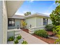 Inviting walkway leading to the front door surrounded by lush landscaping at 1306 Idlewood Dr # 53, Sun City Center, FL 33573