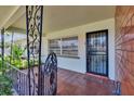 Inviting front porch with decorative ironwork and tiled flooring, offering a charming entrance at 1530 Erin Ln, Clearwater, FL 33755