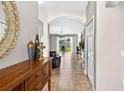 Inviting entryway featuring tile floors, a wooden console table and an arched doorway at 19028 Narimore Dr, Land O Lakes, FL 34638