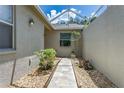 Charming courtyard with stone pathway and decorative plants, creating a welcoming entrance at 21248 Diamonte Dr, Land O Lakes, FL 34637