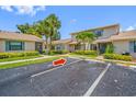 An exterior view of the condo complex features lush landscaping and ample parking at 2131 Ridge S Rd # 19, Largo, FL 33778