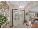 Inviting foyer showcasing decorative glass double doors and elegant light fixture at 2174 Kent Ave, Clearwater, FL 33764