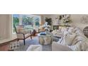 Well-lit living room with cozy seating, area rug, and charming decor at 2174 Kent Ave, Clearwater, FL 33764
