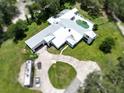 Expansive aerial view showcasing the home's sprawling layout and the lush landscaping that surrounds the property at 21921 Us Highway 98, Dade City, FL 33523