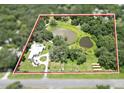 Aerial view displaying the entire property with serene ponds and lush greenery within the property boundary at 21921 Us Highway 98, Dade City, FL 33523