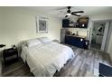 Comfortable bedroom featuring a cozy sleeping area and a compact kitchenette at 2509 Thornbrook Pl, Tampa, FL 33618