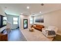 Bright living room with hardwood floors, comfortable seating, and natural light at 2568 13Th N Ave # 2568, St Petersburg, FL 33713