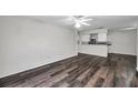 Bright living room boasts hardwood flooring and flows into the kitchen for seamless entertaining at 36243 Lake Chase Blvd # 102, Zephyrhills, FL 33541