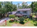 Aerial side view of the home features a lush landscaped yard and charming outdoor space at 4030 Braesgate Ln, Tampa, FL 33624