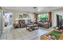 Spacious living room featuring neutral tones, tile flooring, and ample seating at 525 Skylark Nw Ln, Port Charlotte, FL 33952