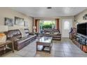 Comfortable living room with tile floors, large window, and cozy seating at 525 Skylark Nw Ln, Port Charlotte, FL 33952