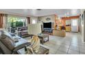 Bright living area with tile flooring, large window, and seamless flow to the kitchen at 525 Skylark Nw Ln, Port Charlotte, FL 33952