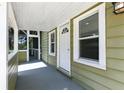 Inviting front porch featuring a white front door, neutral siding, and an adjacent screened porch at 6301 Hobson Ne St, St Petersburg, FL 33702