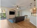 Bright living room featuring wood floors, ceiling fan, and sliding glass doors to the patio at 7001 Interbay Blvd # 219, Tampa, FL 33616