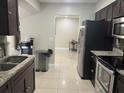 Modern kitchen features dark cabinets, granite countertops, and stainless steel appliances at 7321 W Pocahontas Ave, Tampa, FL 33634