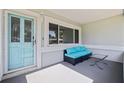 Welcoming front porch with seating area, blue door, and great natural light at 8200 31St N Ter, St Petersburg, FL 33710