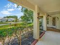 Inviting covered patio with decorative elements and lush landscaping, offering a serene outdoor space at 8336 Monaco Dr # A, Port Richey, FL 34668