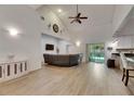 Bright and open living room featuring vaulted ceilings, wood floors, and a sliding door to the backyard at 9041 58Th N St, Pinellas Park, FL 33782