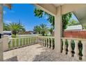 Cozy front porch with tile flooring and decorative railings, perfect for enjoying the outdoors at 9041 58Th N St, Pinellas Park, FL 33782