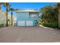 Lovely two-story beach house with a spacious garage and charming curb appeal at 20060 Gulf Blvd, Indian Shores, FL 33785