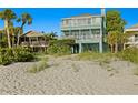 Beautiful beach house with multiple balconies offering stunning views of the ocean at 20060 Gulf Blvd, Indian Shores, FL 33785