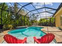 Relaxing screened pool with mature tropical landscaping, perfect for outdoor enjoyment at 11125 Shelter Cove Loop, New Port Richey, FL 34654
