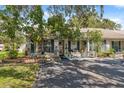 Charming home exterior featuring lush landscaping and inviting curb appeal at 1136 Thayer St, Safety Harbor, FL 34695