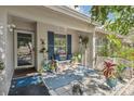 Cozy front porch with seating area and decorative plants creating a welcoming entrance at 1136 Thayer St, Safety Harbor, FL 34695