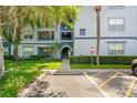 Condo exterior view features manicured landscaping, an exterior stairwell, and a clearly marked parking area at 1640 Villa Capri Cir # 206, Odessa, FL 33556