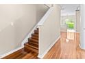Elegant staircase featuring hardwood steps and flooring at 2020 Greenwood Valley Dr, Plant City, FL 33563