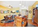 Spacious game room with a wooden bar, poker table, and multiple televisions for entertainment at 25950 Risen Star Dr, Wesley Chapel, FL 33544