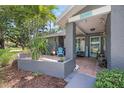 Inviting front porch with tiled floor, charming decor, and a welcoming atmosphere at 2850 Doone Cir, Palm Harbor, FL 34684