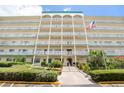 Front exterior of the building with flag and landscaping at 2960 59Th S St # 215, Gulfport, FL 33707