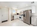 Bright kitchen with stainless steel appliances, white cabinets, and tile floors at 2960 59Th S St # 215, Gulfport, FL 33707