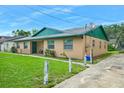 Well-maintained single story home with a green roof and a sidewalk leading to the front door at 312 E Tomlin St, Plant City, FL 33563