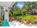 Beautifully landscaped front yard with mulch, vibrant plants, and a glimpse of the charming neighborhood at 3129 W Villa Rosa St, Tampa, FL 33611