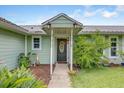 Inviting front entrance with a decorative wreath and charming outdoor lighting at 3515 E 34Th St, Bradenton, FL 34208