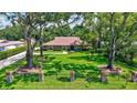 A beautiful brick home with a large landscaped front lawn and mature shade trees at 3923 Hudson Ln, Tampa, FL 33618
