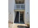 Condominium exterior featuring stucco walls, an entry way, stairwell, and overhead lighting at 4611 W North B St # 228, Tampa, FL 33609