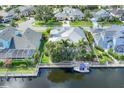 Waterfront home featuring a private dock, boat lift and lush landscaping at 4743 Spinnaker Dr, Bradenton, FL 34208
