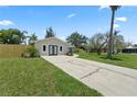 Attractive single-story home featuring a spacious front lawn, new fence, and a long concrete driveway at 561 Golf And Sea Blvd, Apollo Beach, FL 33572