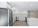 Modern kitchen features new stainless steel appliances, white cabinetry, and quartz countertops at 561 Golf And Sea Blvd, Apollo Beach, FL 33572