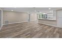 Open concept living area featuring new vinyl plank flooring that connects to an adjacent kitchen at 561 Golf And Sea Blvd, Apollo Beach, FL 33572